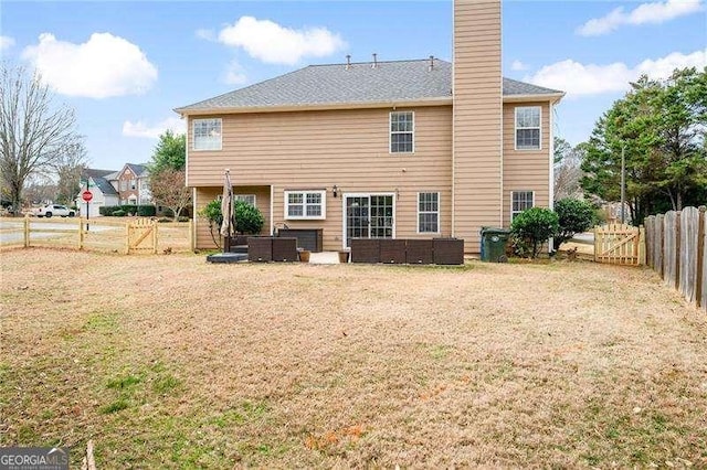 back of property with a yard and an outdoor hangout area