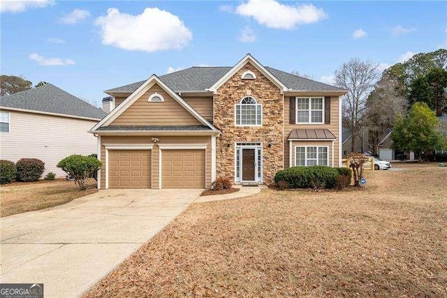 view of front of property featuring a garage and a front yard