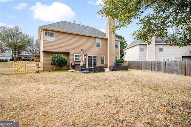 rear view of property with outdoor lounge area and a yard