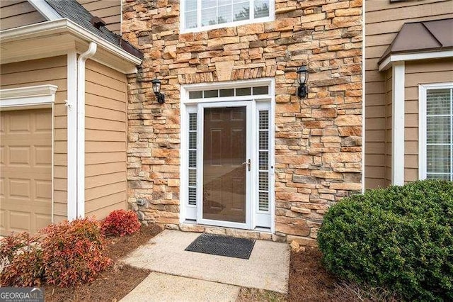 doorway to property featuring a garage