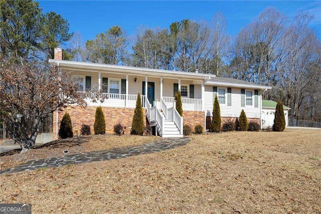 ranch-style house featuring a front yard and covered porch