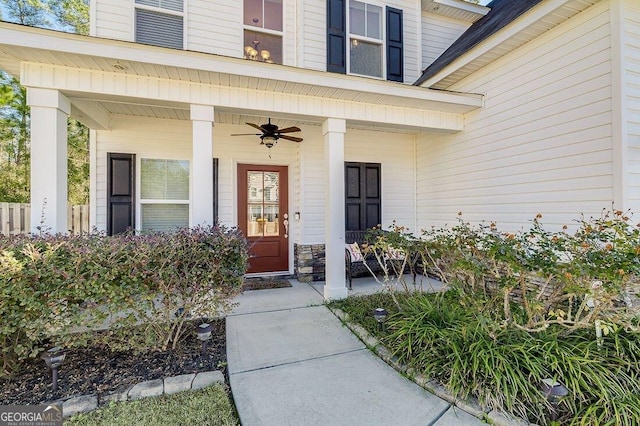 entrance to property featuring a porch and ceiling fan