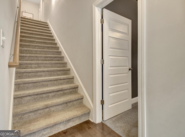 stairway with hardwood / wood-style flooring