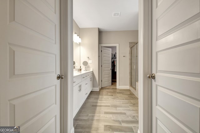 bathroom with vanity and walk in shower