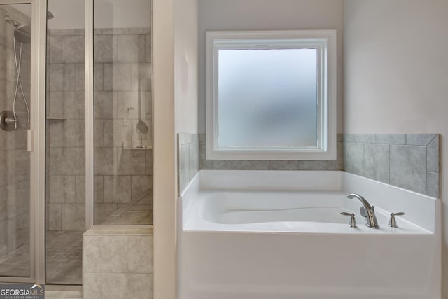 bathroom with shower with separate bathtub