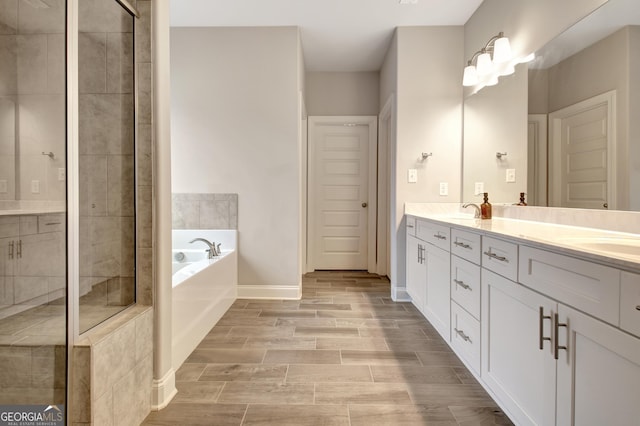 bathroom featuring independent shower and bath and vanity