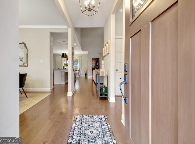 foyer entrance featuring hardwood / wood-style flooring and a chandelier