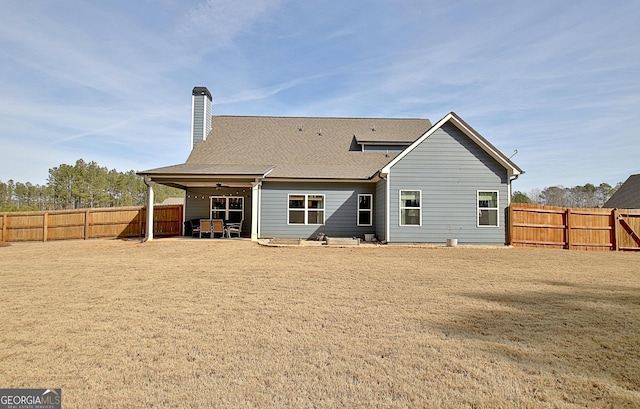 rear view of house featuring a lawn and a patio area