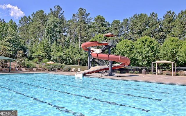 view of pool with a water slide