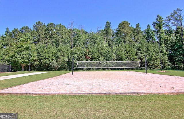 view of property's community with a yard and volleyball court