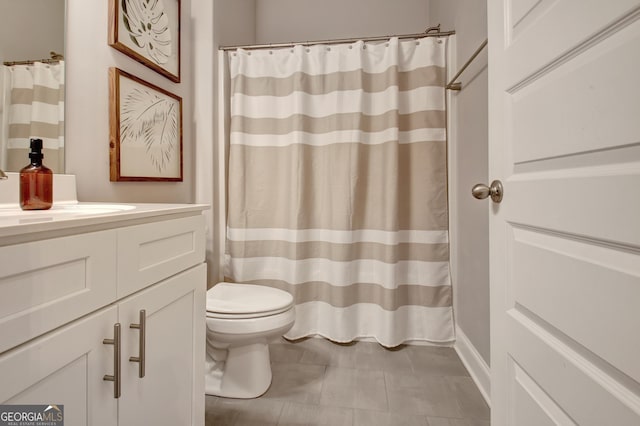 bathroom with vanity, toilet, and tile patterned flooring