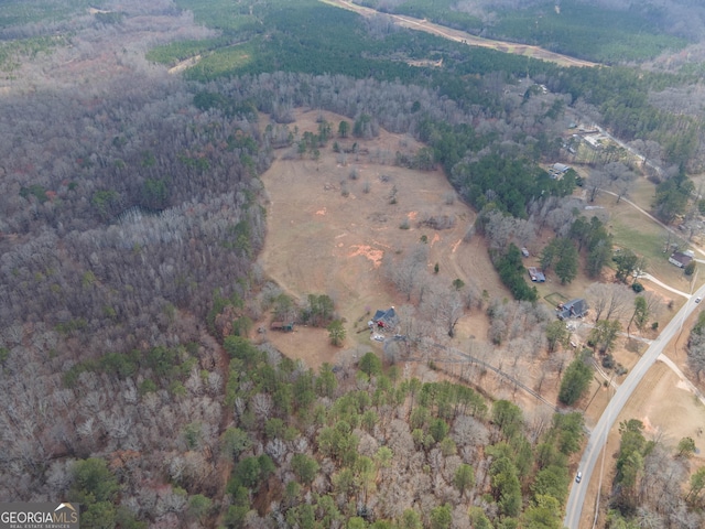 birds eye view of property featuring a rural view and a wooded view