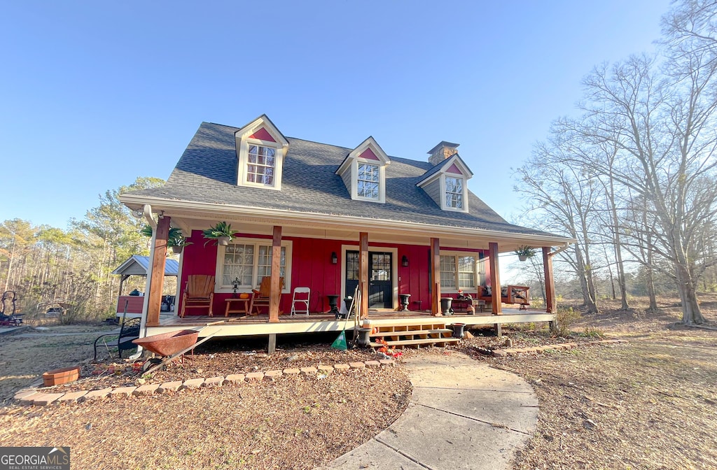 view of front of property featuring a porch and a shingled roof