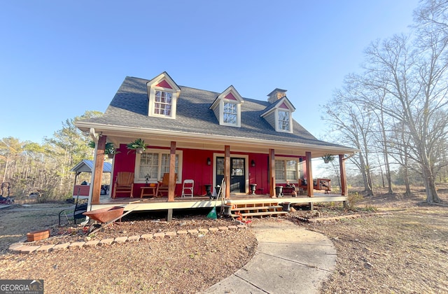 view of front of property featuring a porch and a shingled roof