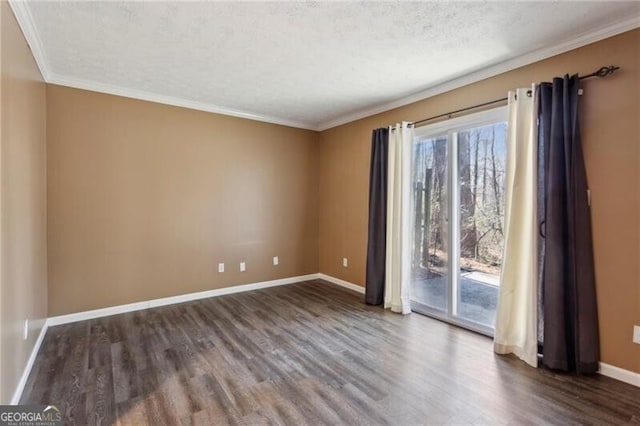 spare room featuring dark wood-type flooring, plenty of natural light, and a textured ceiling