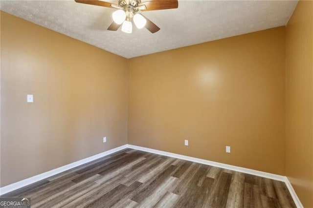 empty room featuring ceiling fan, dark hardwood / wood-style floors, and a textured ceiling