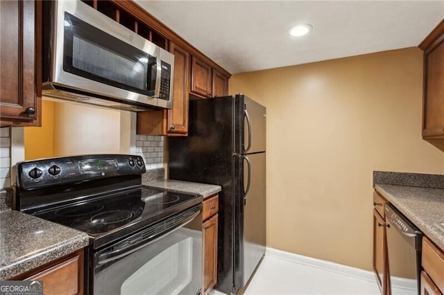 kitchen featuring backsplash and black appliances