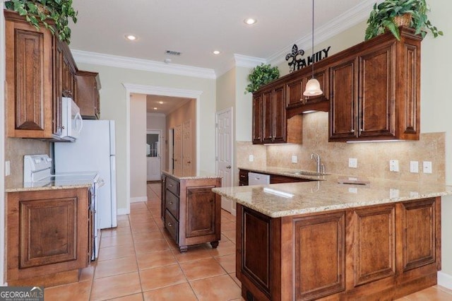 kitchen featuring sink, white appliances, hanging light fixtures, light stone counters, and kitchen peninsula