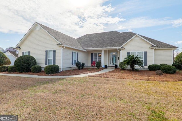 single story home featuring a front lawn