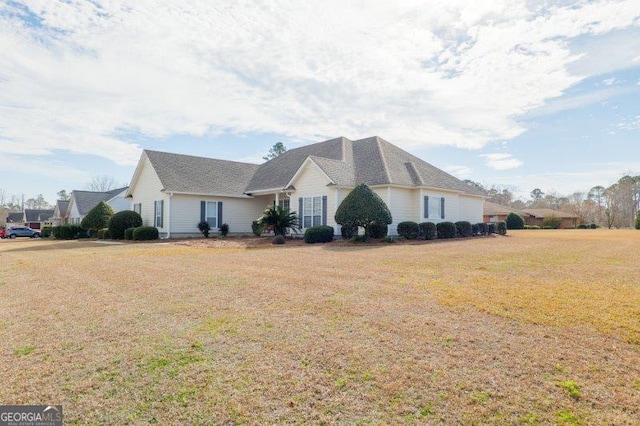 view of home's exterior with a lawn