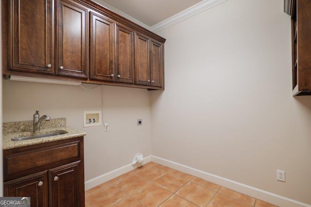 laundry area featuring sink, electric dryer hookup, hookup for a washing machine, cabinets, and ornamental molding