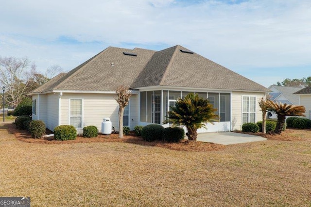 back of house featuring a patio area and a lawn