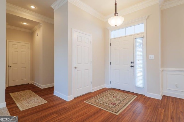 foyer featuring ornamental molding and dark hardwood / wood-style floors