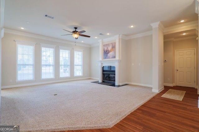 unfurnished living room with crown molding, carpet floors, and ceiling fan