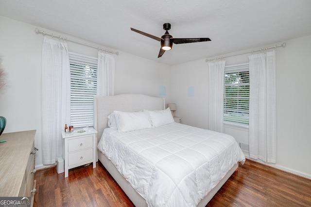 bedroom with dark wood-type flooring and ceiling fan