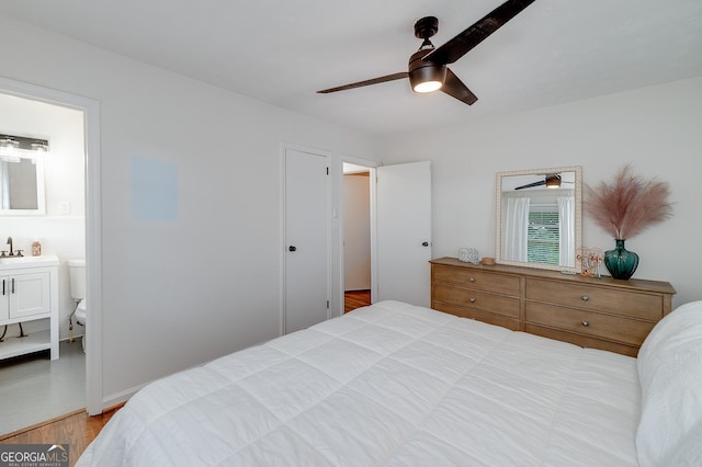 bedroom with ceiling fan, connected bathroom, sink, and light wood-type flooring