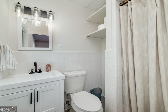 bathroom featuring vanity, tile walls, walk in shower, and toilet