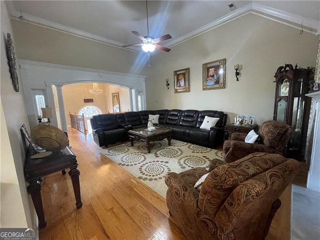 living room featuring ornate columns, ornamental molding, wood-type flooring, and ceiling fan