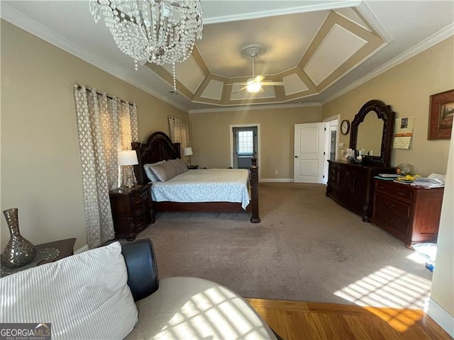 bedroom with a tray ceiling, ceiling fan with notable chandelier, ornamental molding, and carpet