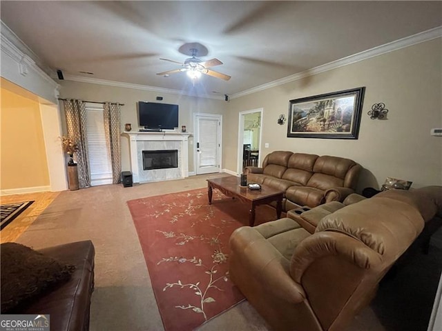 living room with crown molding, carpet floors, ceiling fan, and a fireplace