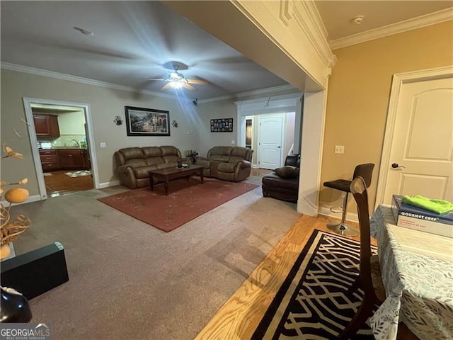 living room featuring ornamental molding, carpet floors, and ceiling fan