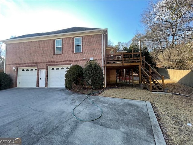 back of house featuring a garage and a deck