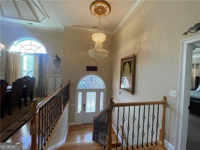 entryway with hardwood / wood-style floors and ornamental molding