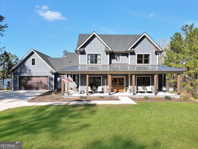 modern farmhouse style home with a garage, covered porch, and a front lawn