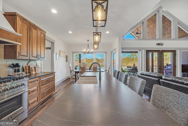 dining space featuring french doors, an inviting chandelier, dark hardwood / wood-style flooring, and sink