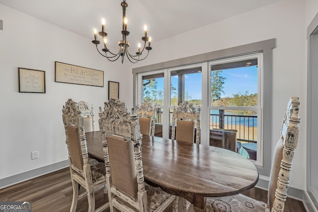 dining area featuring a notable chandelier and dark hardwood / wood-style floors