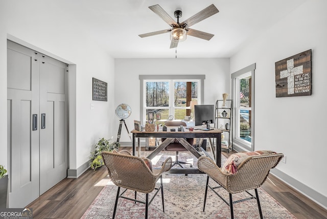 office area with dark wood-type flooring and ceiling fan