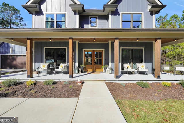 back of house with covered porch and french doors