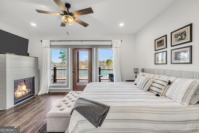 bedroom featuring ceiling fan, dark hardwood / wood-style flooring, and access to outside