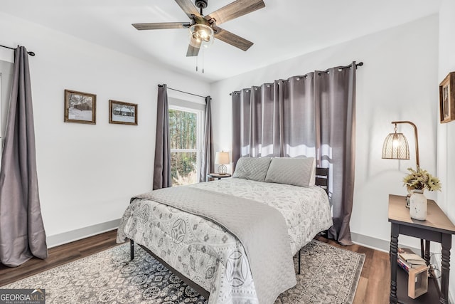 bedroom with ceiling fan and dark hardwood / wood-style floors