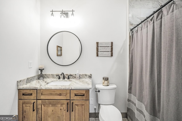 bathroom with vanity, a shower with shower curtain, and toilet