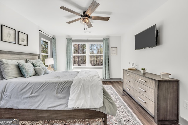 bedroom featuring ceiling fan and dark hardwood / wood-style floors