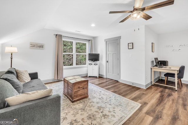 living room with ceiling fan, lofted ceiling, and hardwood / wood-style floors