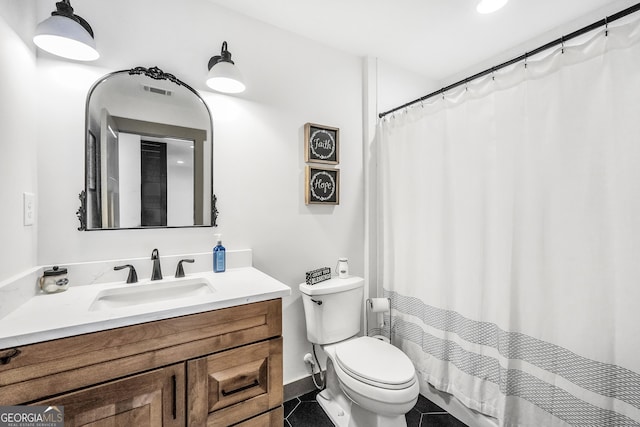 bathroom featuring tile patterned floors, toilet, and vanity