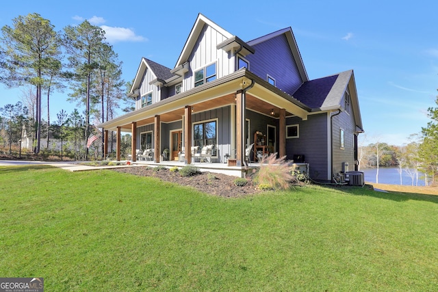 view of front of home featuring cooling unit, a porch, and a front lawn