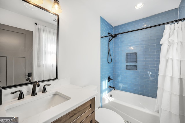 full bathroom featuring shower / tub combo with curtain, vanity, and toilet